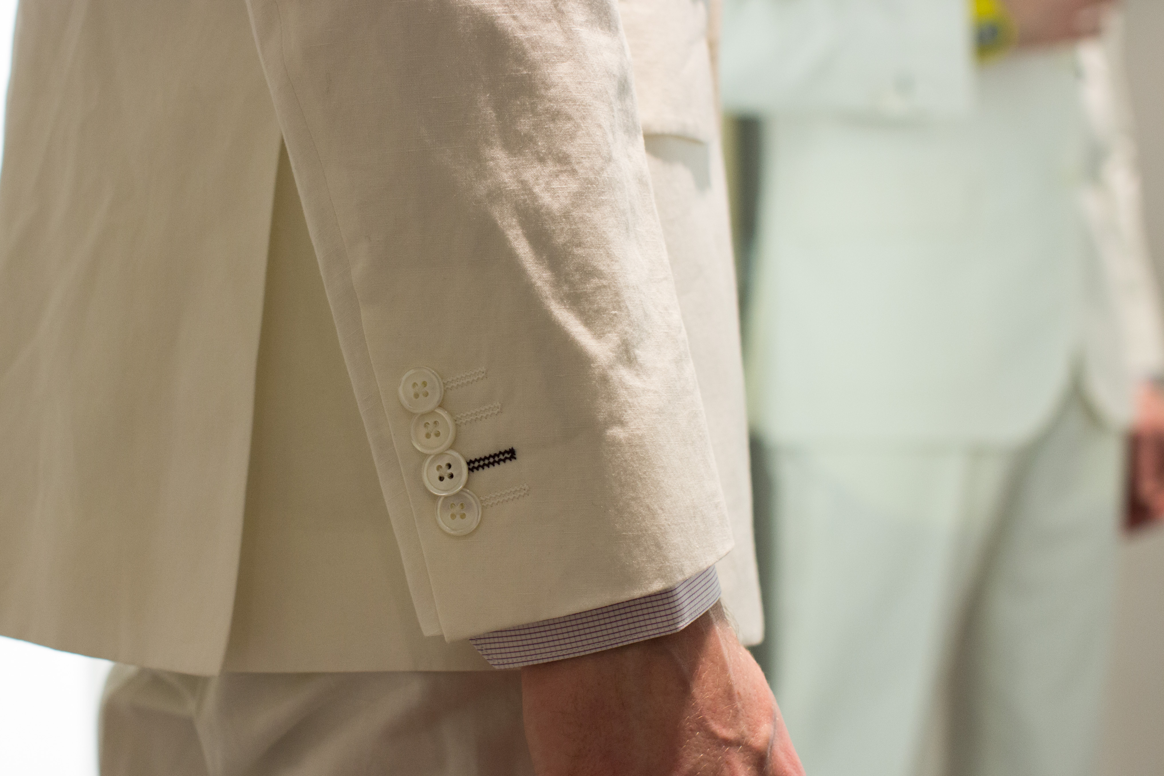 Cuff details on white linen suit at Paul Smith